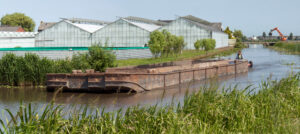 Greenhouse with canal and barge and front