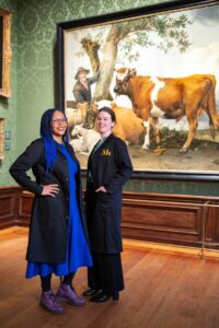 two restorers from the Mauritshuis sit in front of The Bull painting.