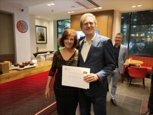 Ton Krol receives 20 year membership appreciation award from Melanie ter Meulen