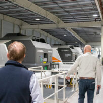 IMG_7658 People looking at a flight simulator.