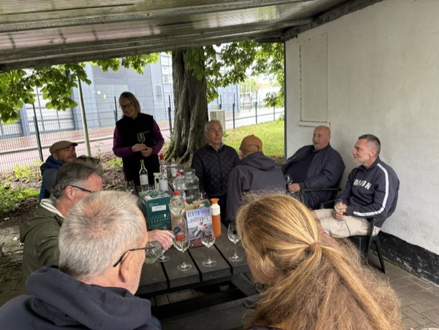Group of people listening to a talk about the city vineyard